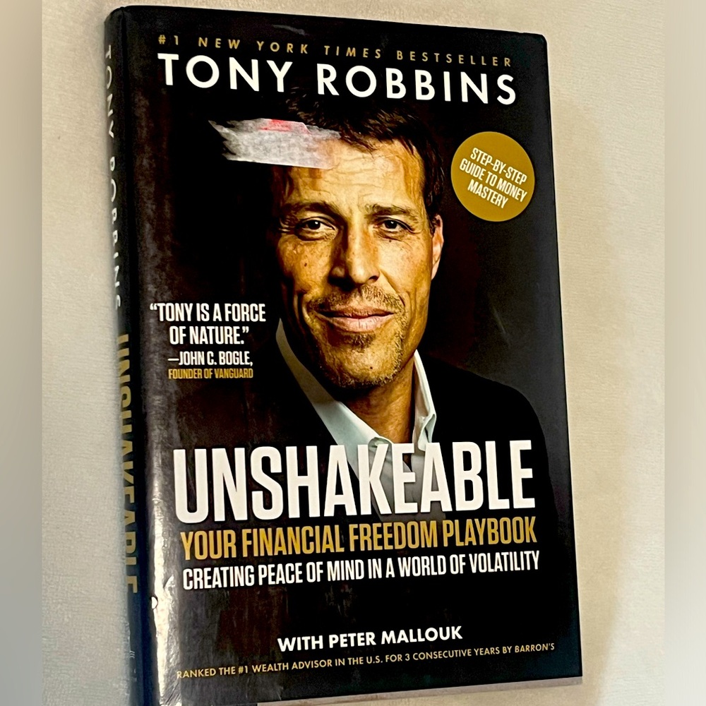 Unshakeable by Tony Robbins Hard Bound Copy in great condition except stickers.